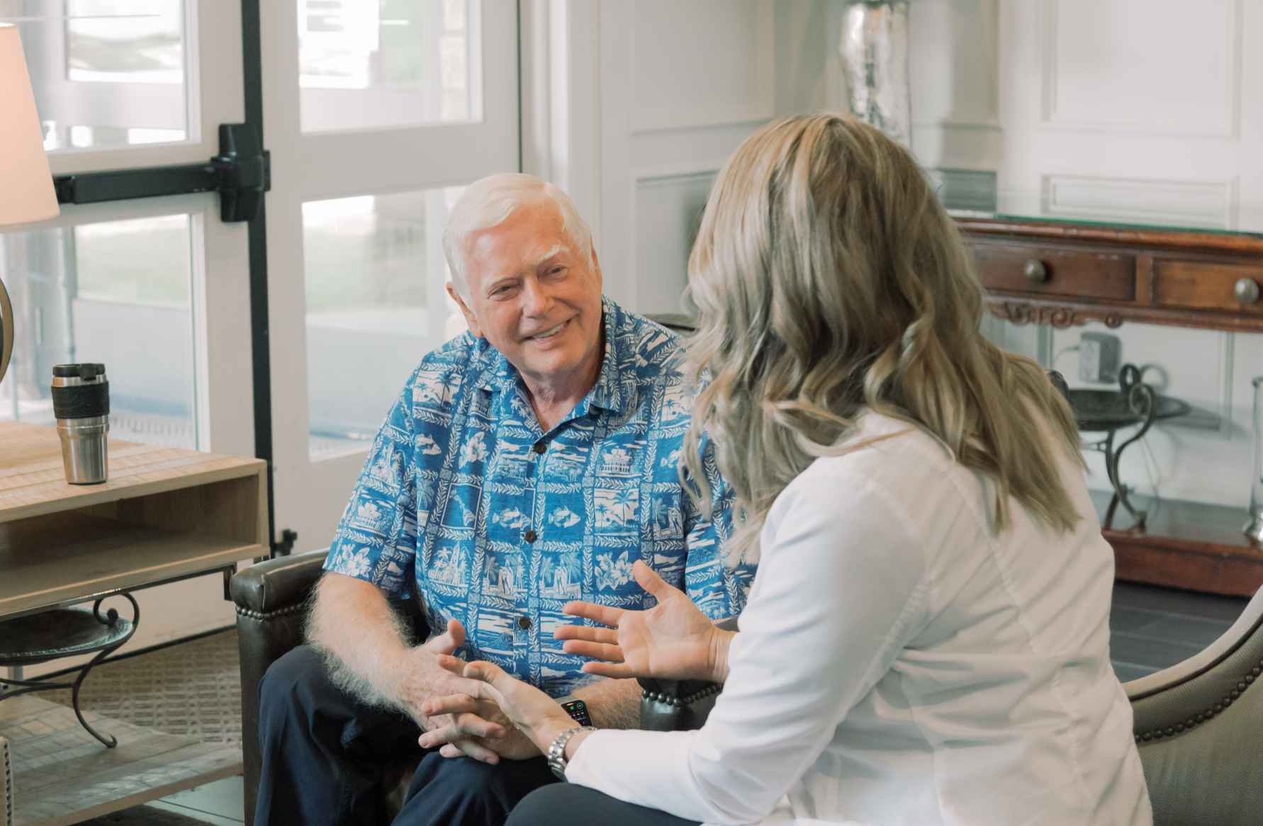 Photo of a man sitting next to Dr. Zatopek