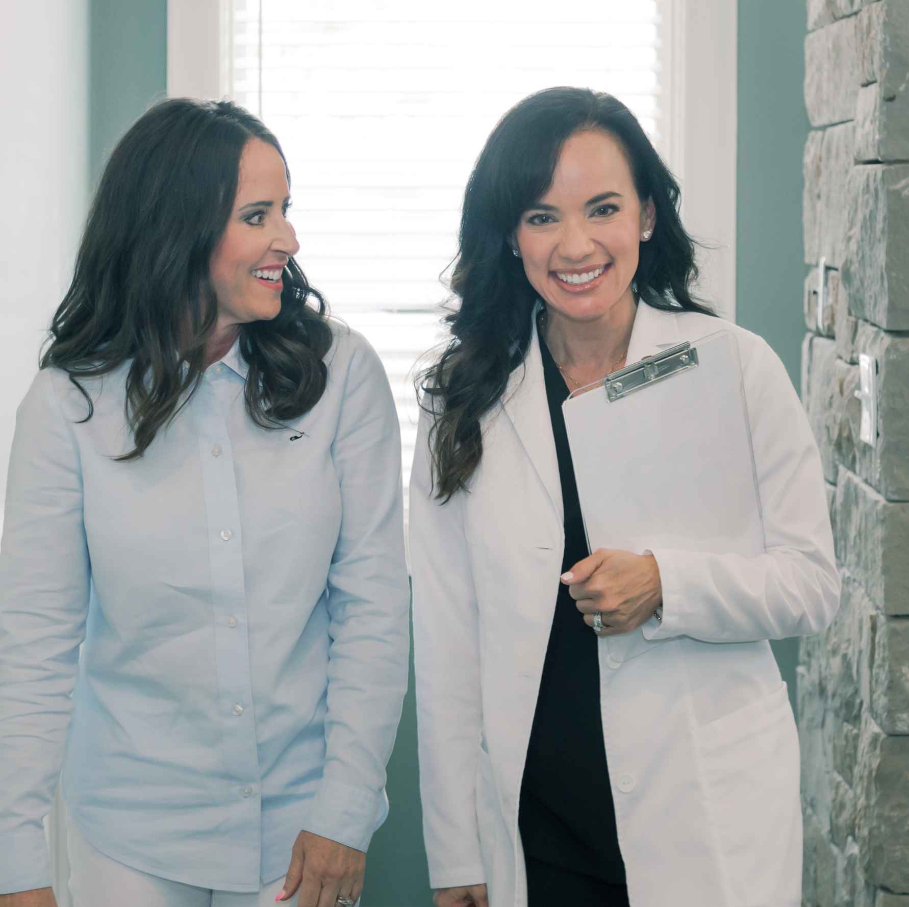 A dentist and patient smiling