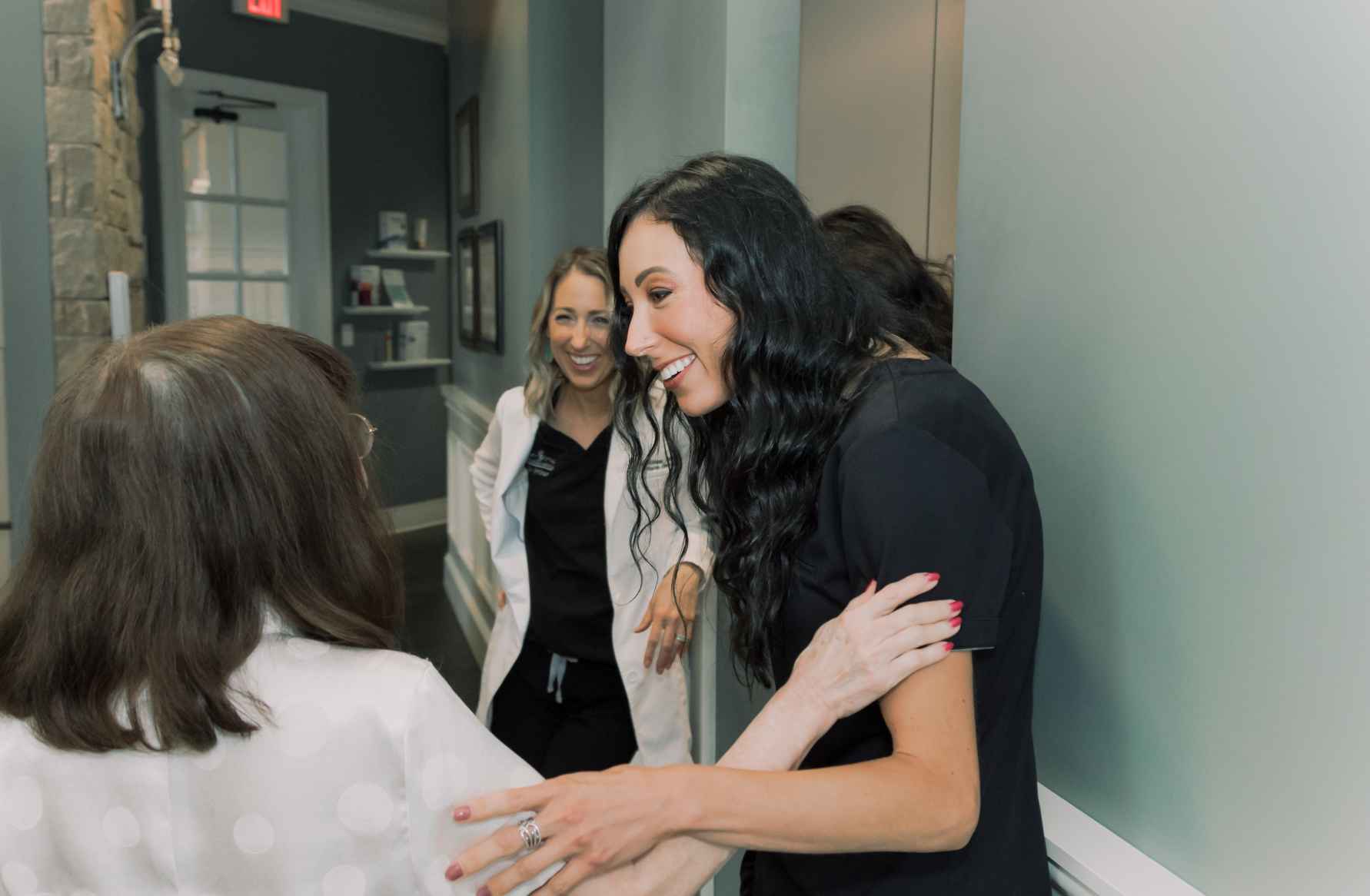 A team member and patient talking in a hallway