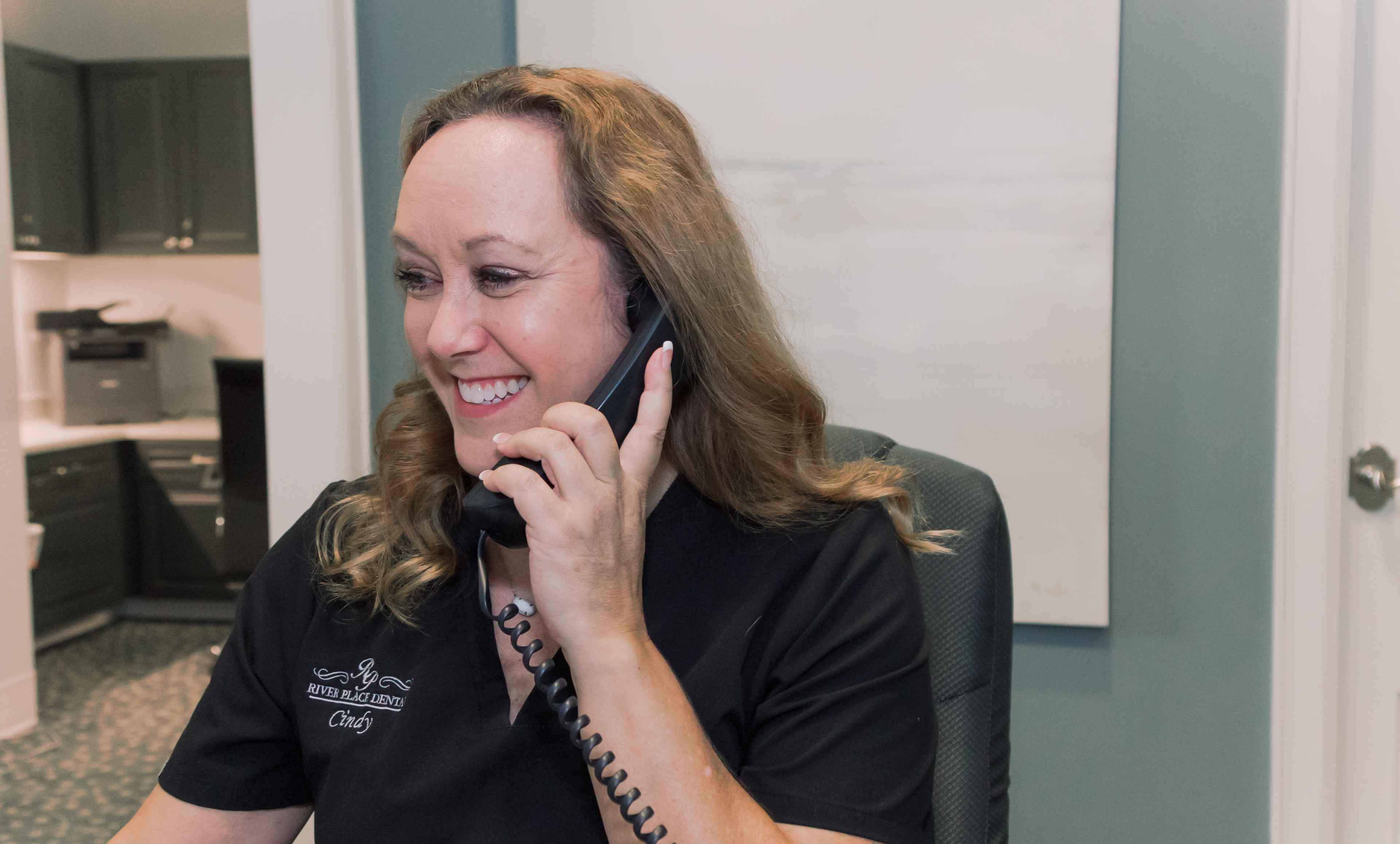 A team member talking on the phone at our reception desk