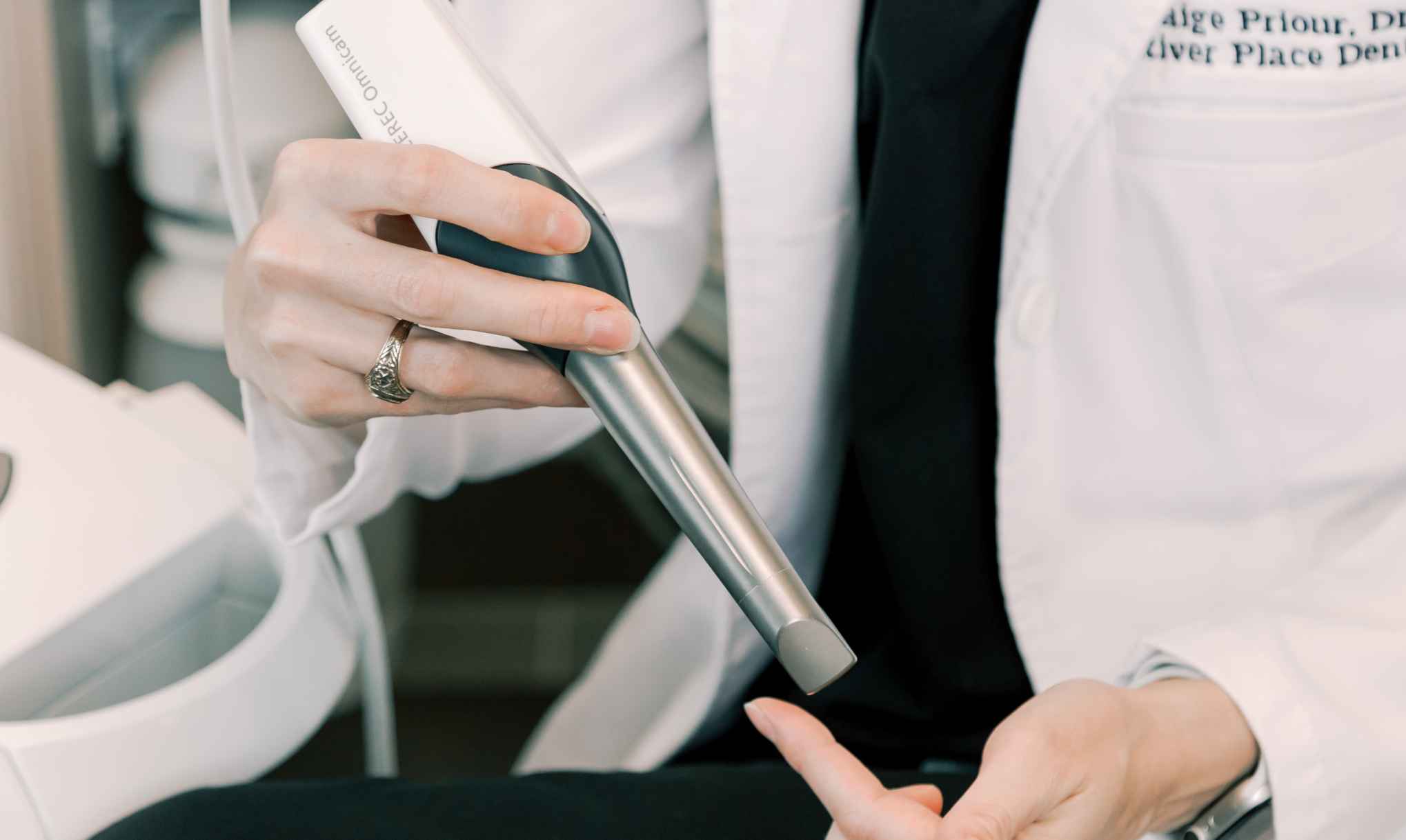 A dentist holding a 3-D oral scanner wand