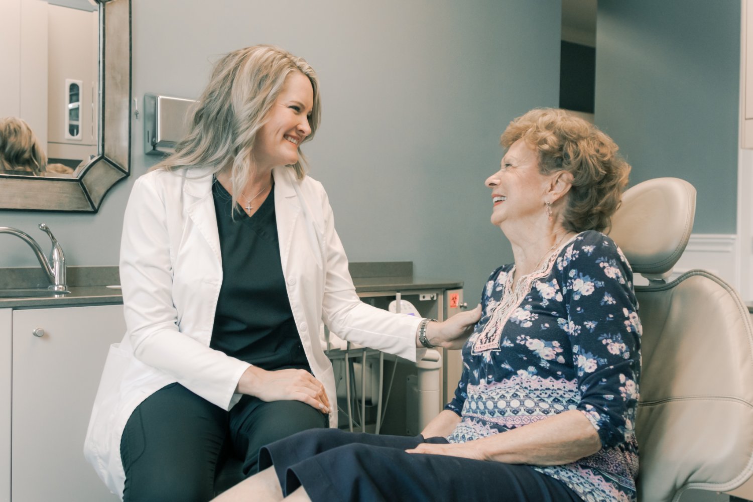 Dr. Zatopec talking with her hand on a patient's shoulder